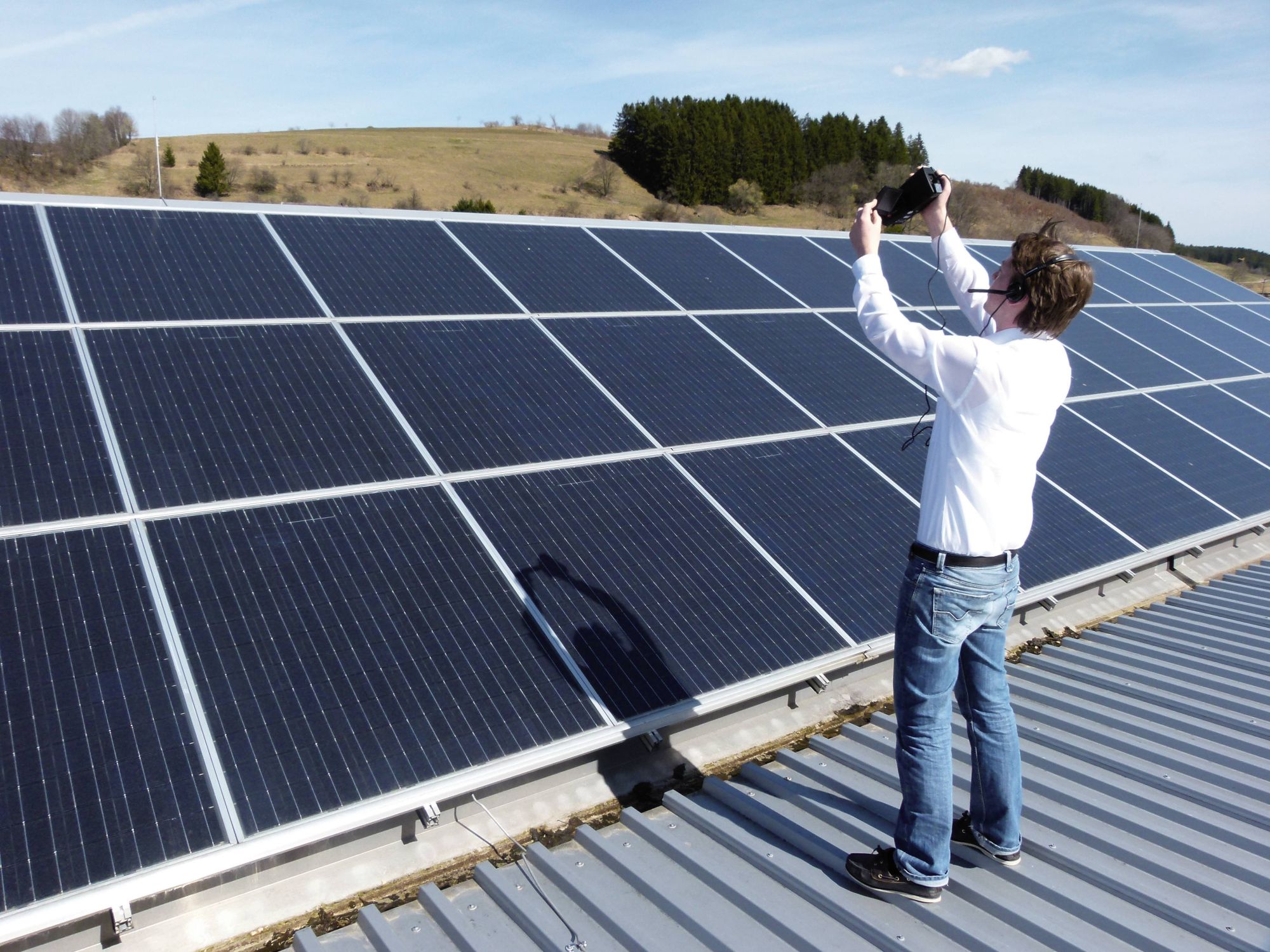 Person thermographically testing photovoltaic plant